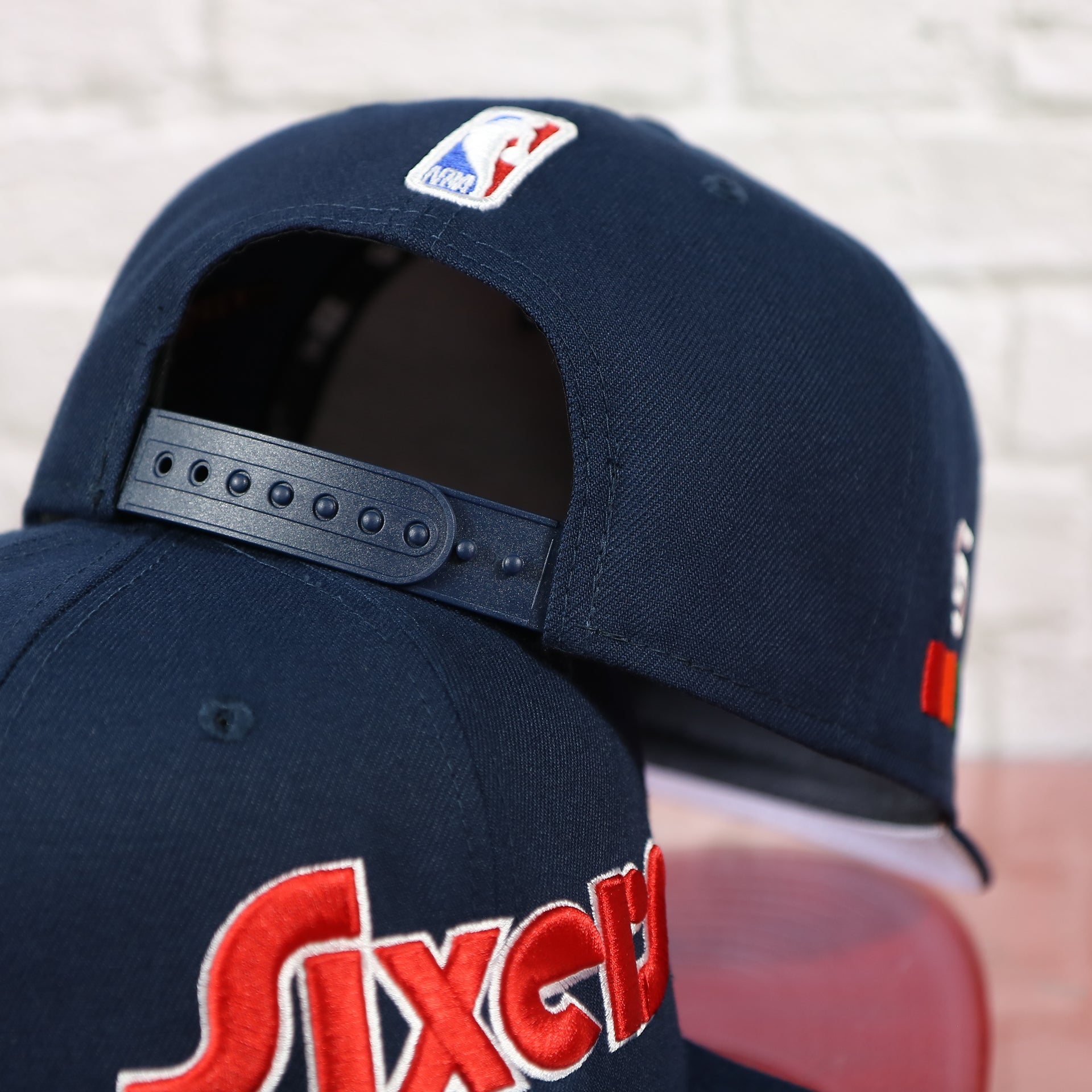 Adjustable snap on the back of the Philadelphia 76ers 2022 City Edition Sixers Script Spectrum Side Patch 9Fifty Snapback Hat