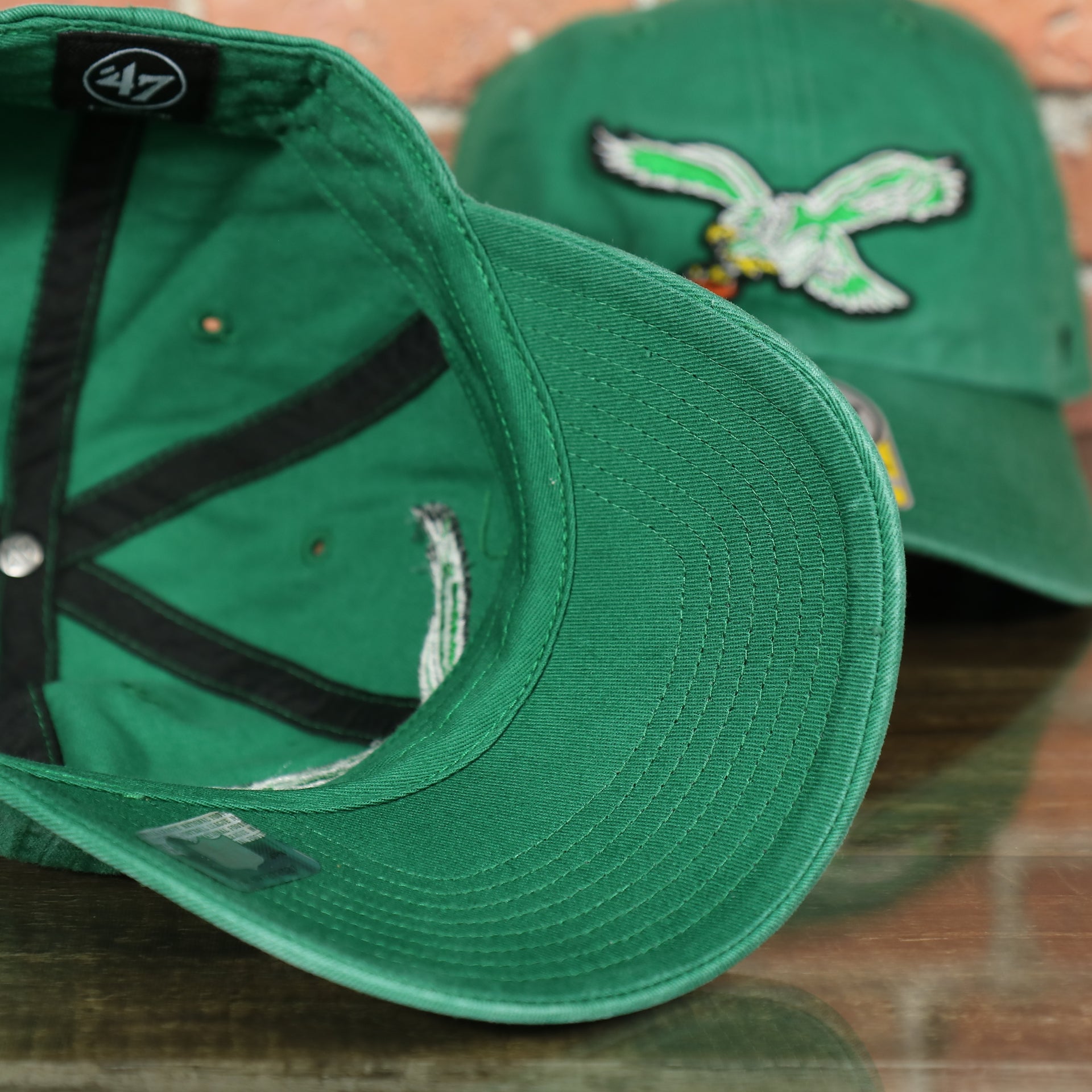 underside of this Philadelphia Eagles Throwback Distressed White Dad Hat Hat | White Adjustable Baseball Cap