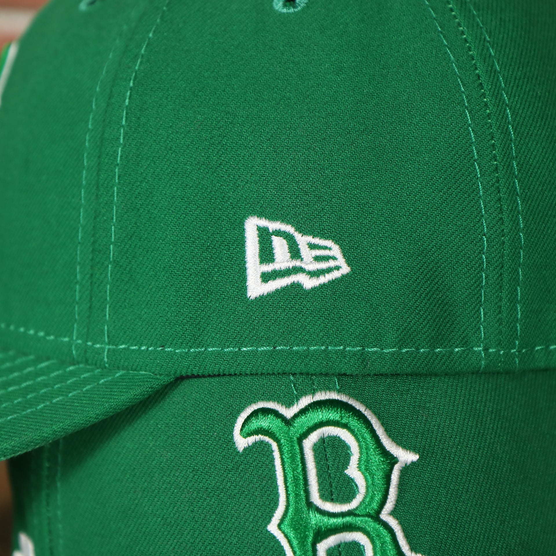 new era logo on the Boston Red Sox ST. Patrick's Dad  Logo Green Bottom Dad Hat | Green Dad Hat