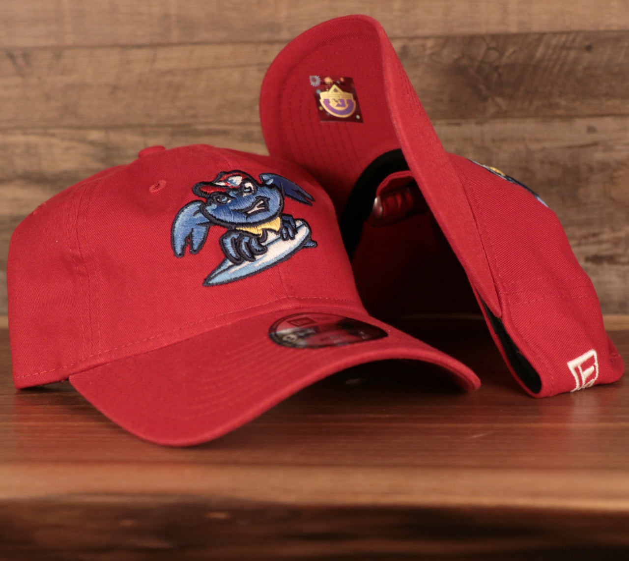 The Jersey Shoe BlueClaws baseball cap is solid red featuring an unstructured crown and a bent brim