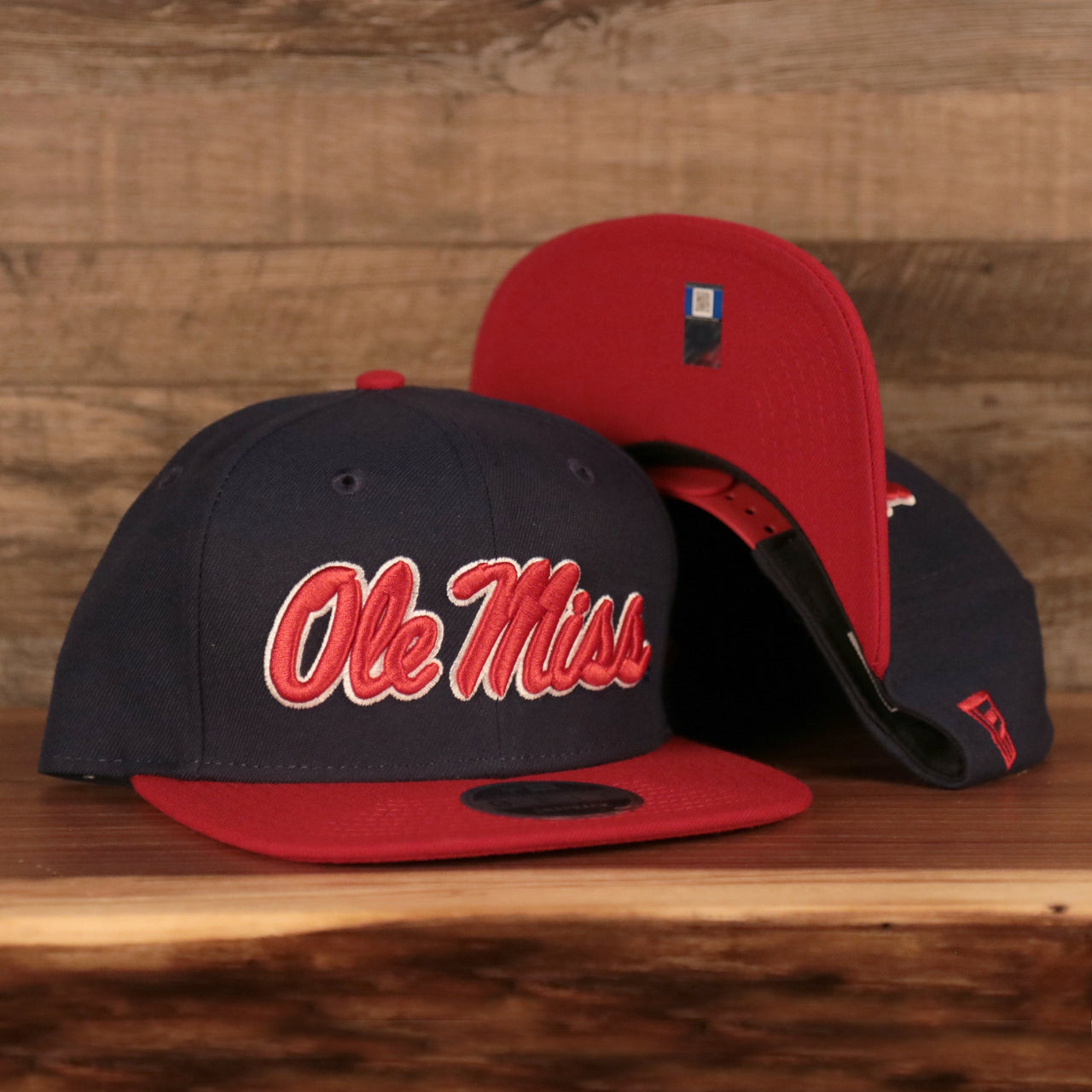 front and bottom of the Ole Miss Rebels Navy Adjustable 9Fifty Orange Brim Snapback Cap