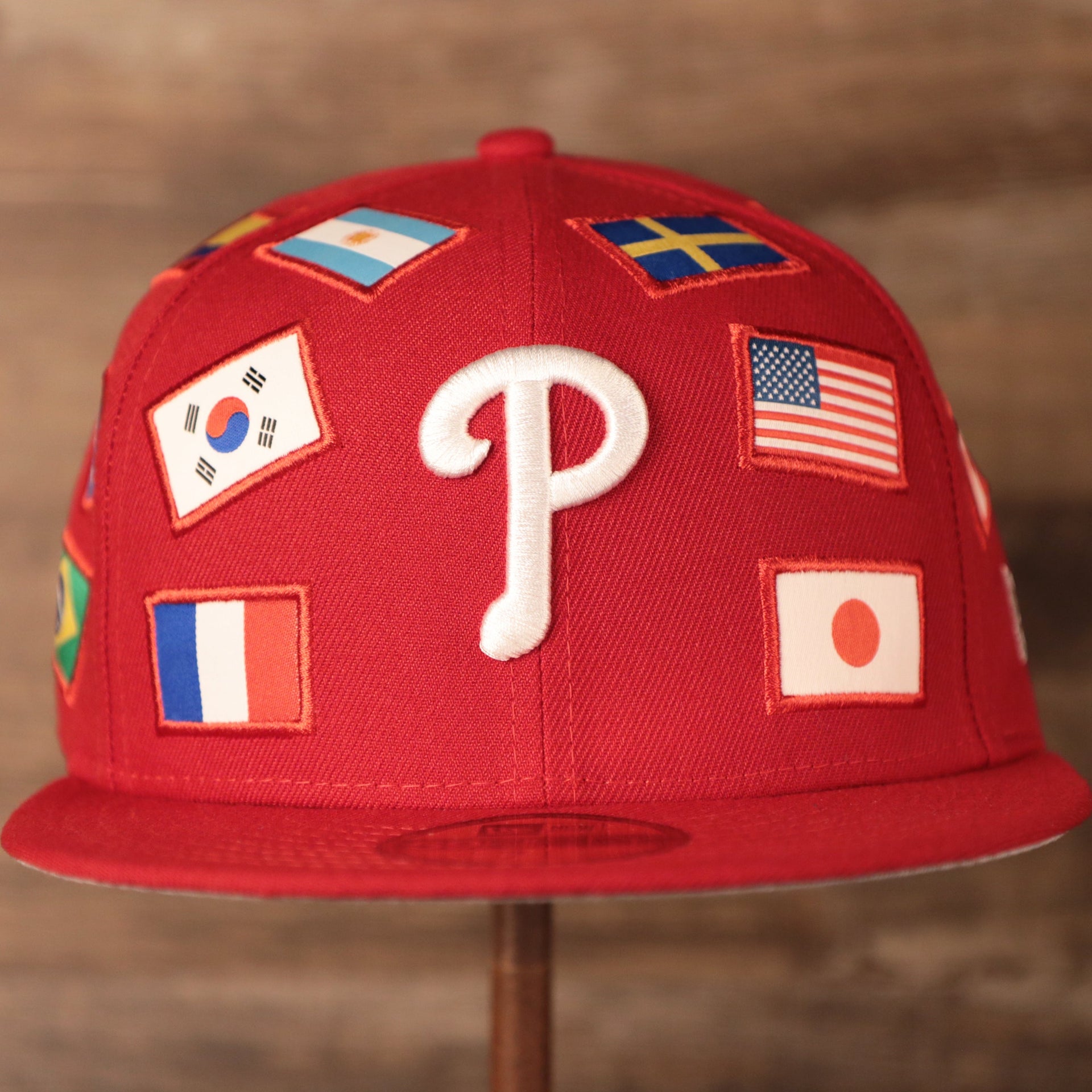 Phillies World Flags Gray Bottom Fitted Cap | Philadelphia Phillies International Flags Red Grey Under Brim Fitted Cap the front of this philies cap has flags from the countries of America, Japan, and France