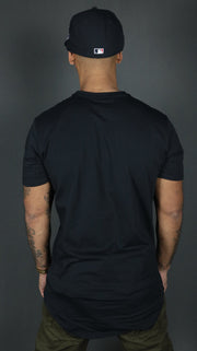The Jordan Craig navy longline scoop bottom tshirt from the back side.