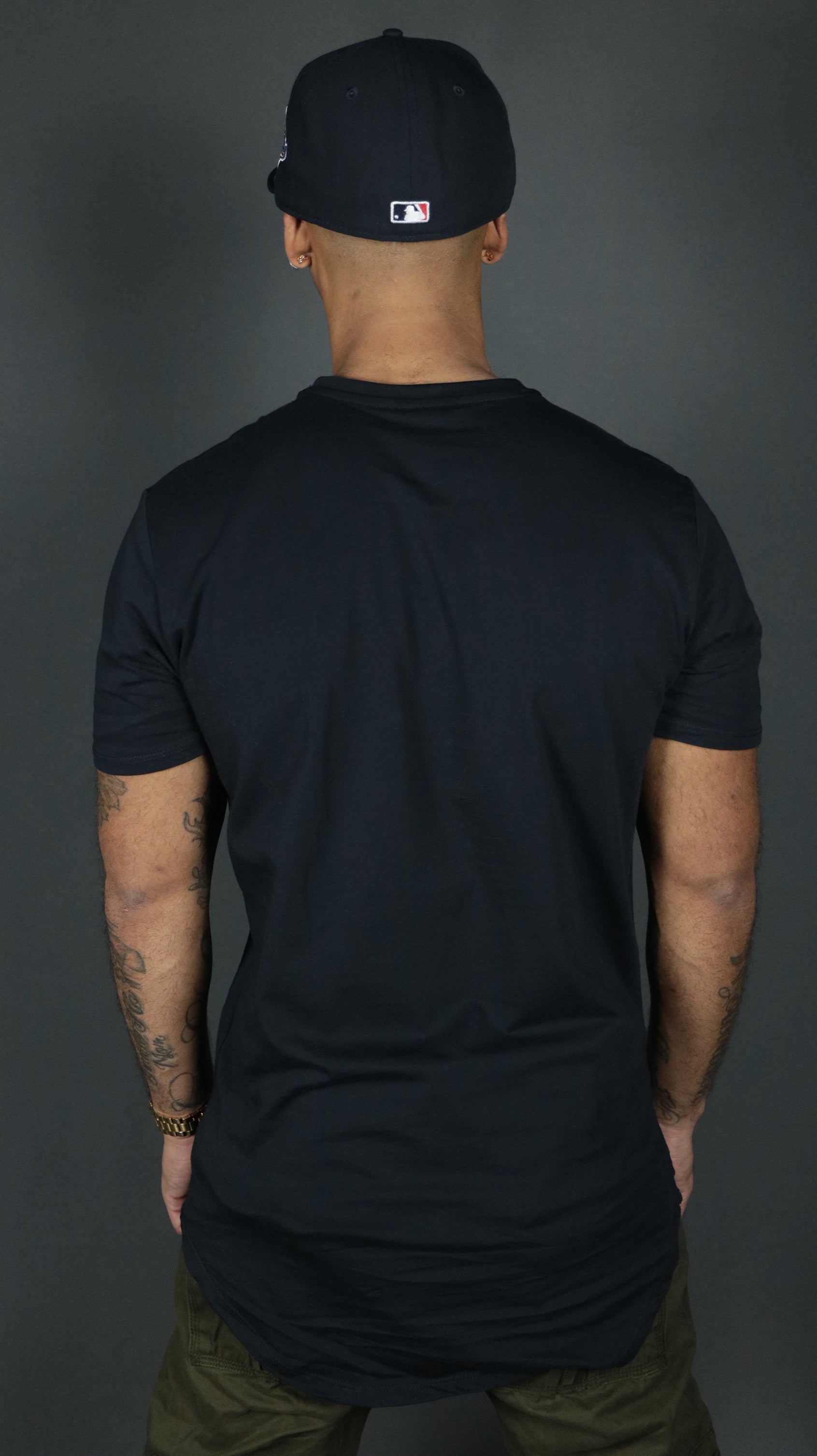 The Jordan Craig navy longline scoop bottom tshirt from the back side.