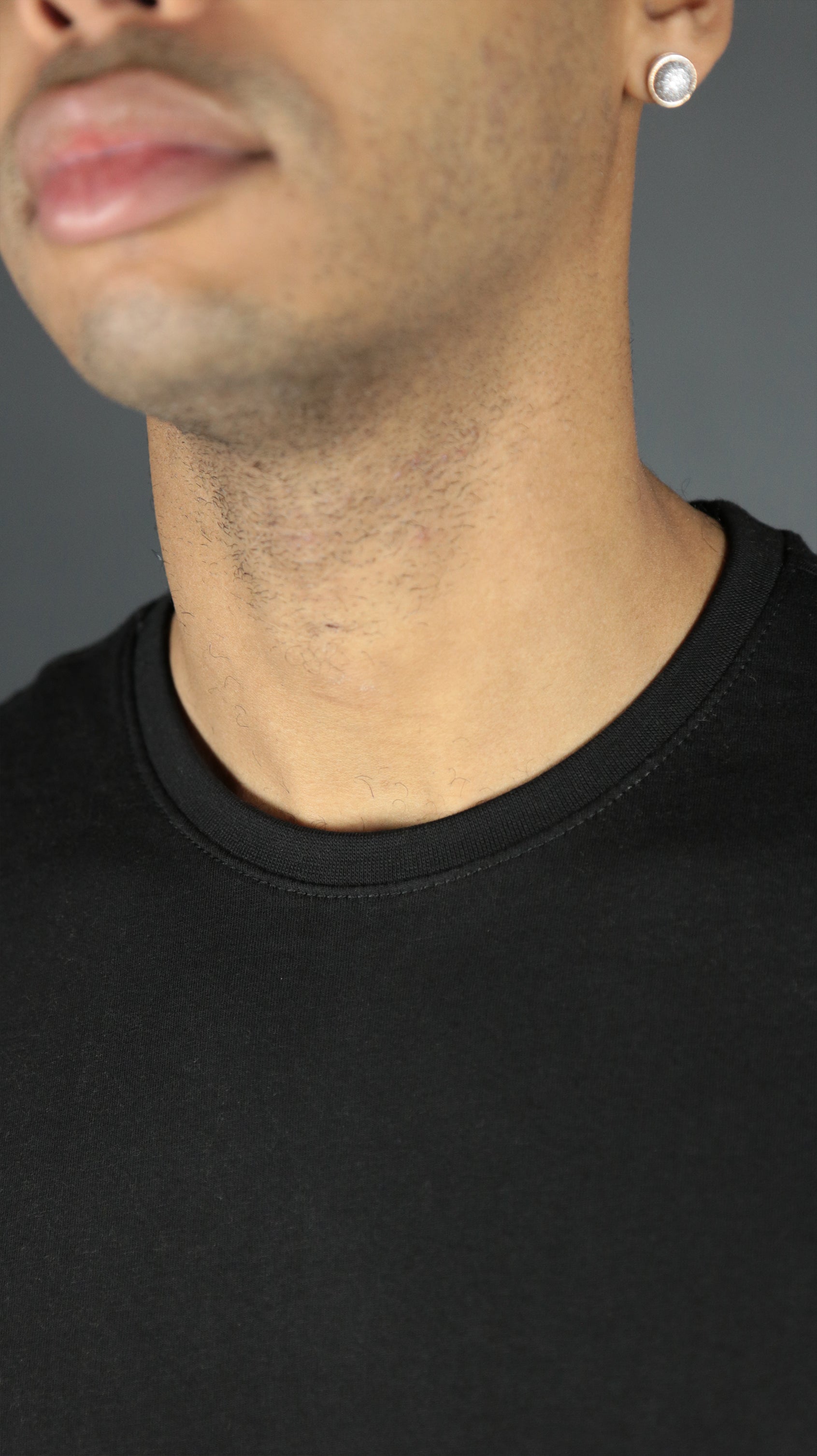 Front design of the black Jordan Craig longline scoop bottom shirt.