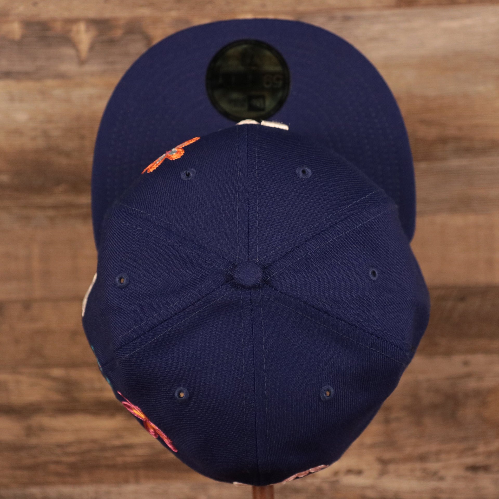 Top down view of the Los Angeles Dodgers All Over Floral Pattern Flower Crotchet Side Patch Pink Bottom 59Fifty Fitted Cap
