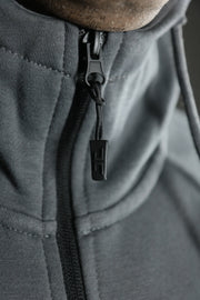 The zipup of the charcoal Jordan Craig basic tech fleece hoodie.