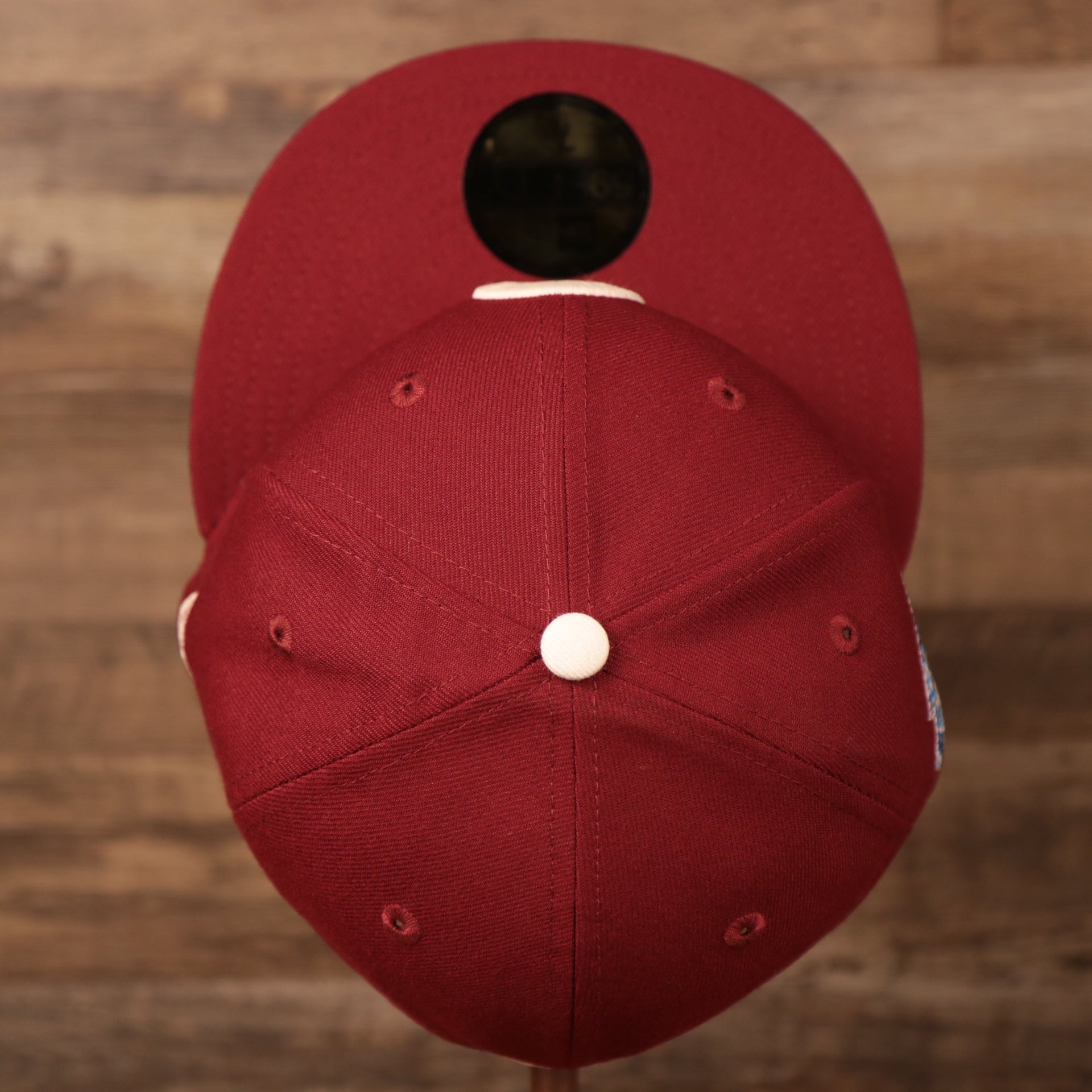 A top view of the crown of the Philadelphia Phillies white floral bottom retro maroon 59fifty hat by New Era.