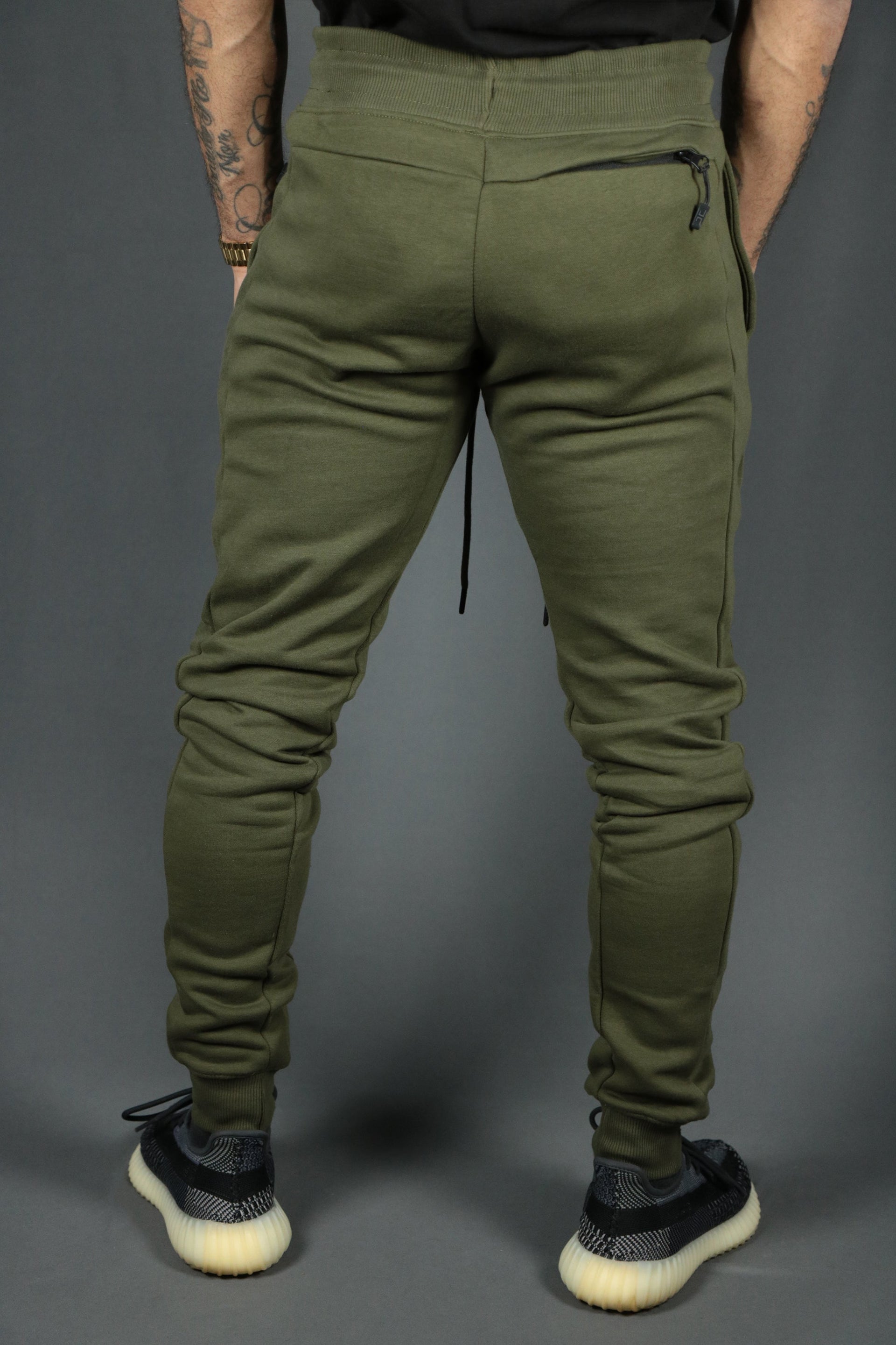 The backside of the Jordan Craig military green sweatpants set.