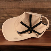 Philadelphia Athletics Royal Blue Logo Retro Cream Dad Hat Bottom view of the cap with '47 Clean Up tag and MLB hologram sticker on its underbrim