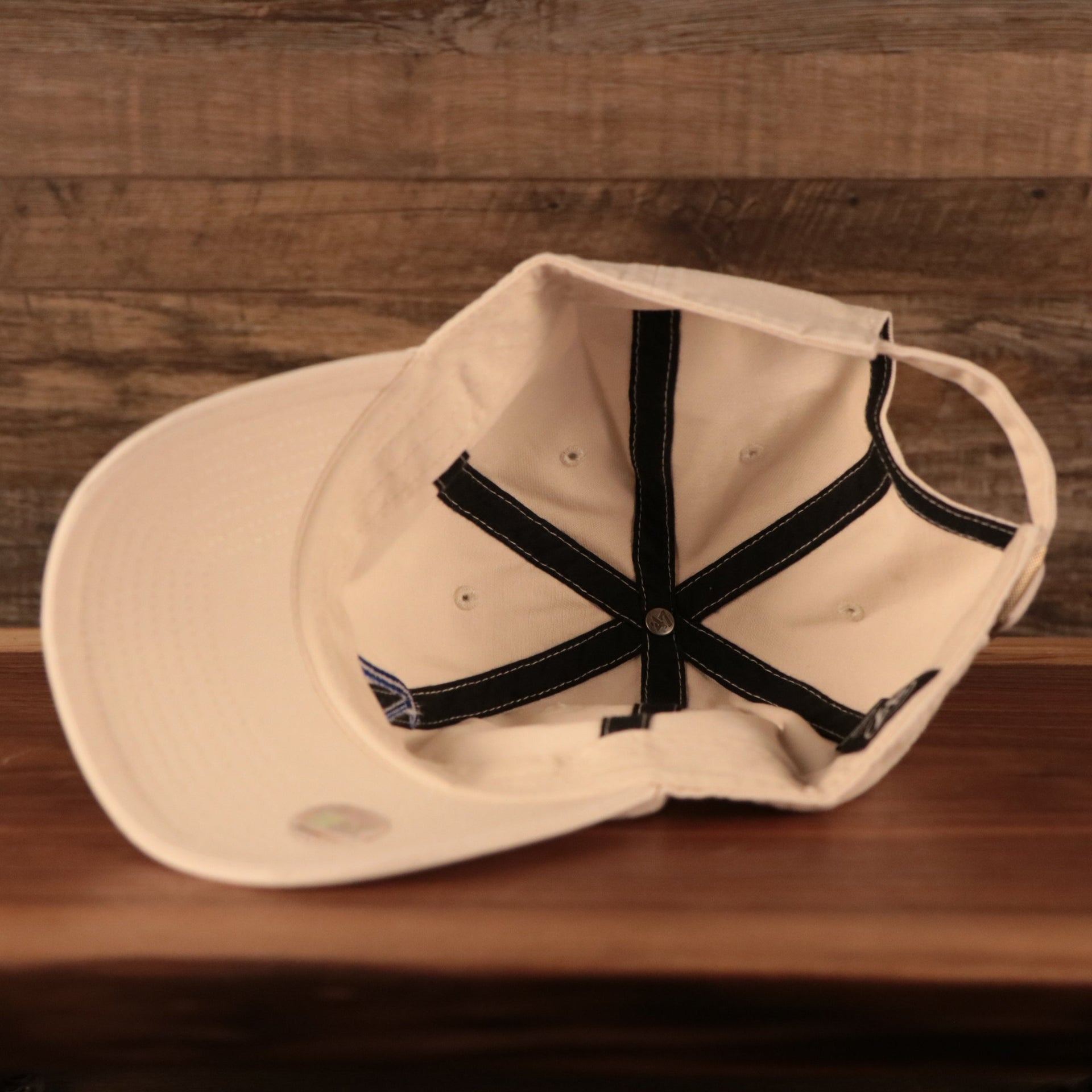 Philadelphia Athletics Royal Blue Logo Retro Cream Dad Hat Bottom view of the cap with '47 Clean Up tag and MLB hologram sticker on its underbrim