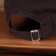 A closeup shot of the adjustable strap at the backside of the New York Yankees 2021 fourth of July navy 920 dad hat.