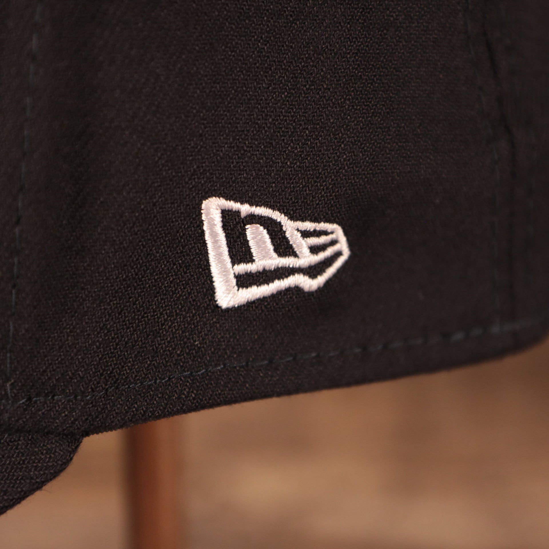 A closeup shot of the white New Era patch on the left side of the navy 2021 fourth of July 39thirty flexfit cap for the New York Yankees by New Era.