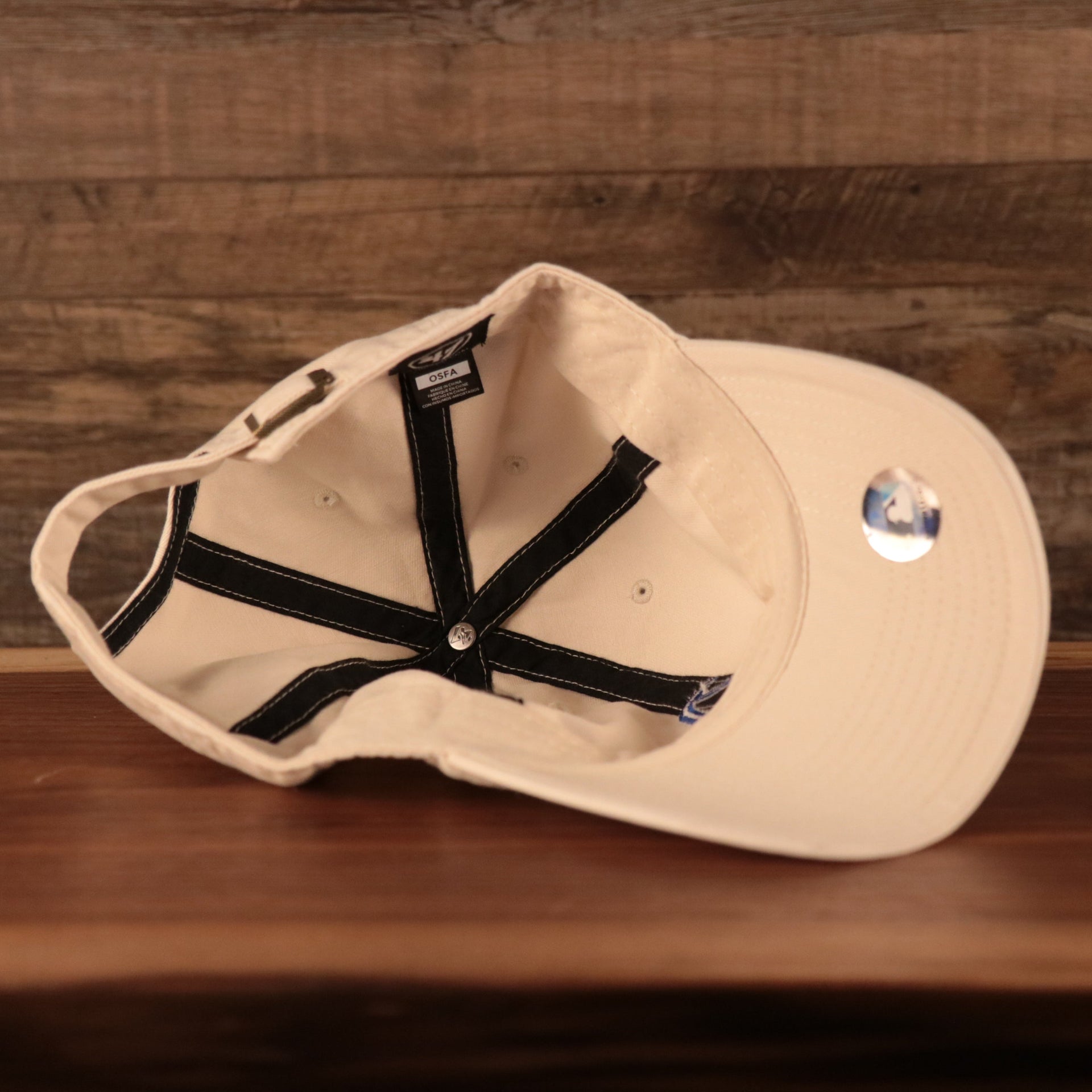 Philadelphia Athletics Royal Blue Logo Retro Cream Dad Hat Bottom view of the cap with '47 Clean Up tag and MLB hologram sticker on its underbrim