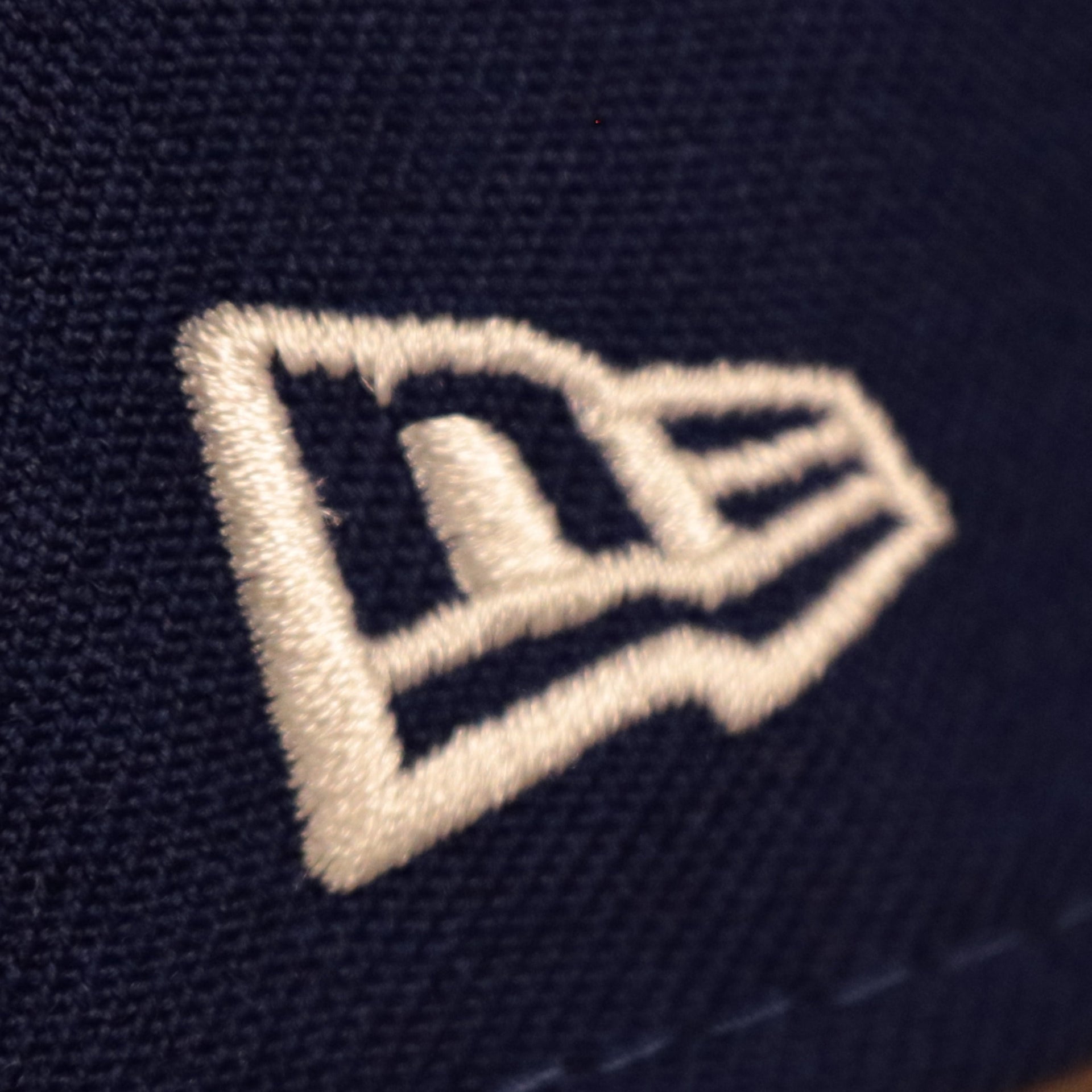 Close up of the New Era flag on the Los Angeles Dodgers All Over Floral Pattern Flower Crotchet Side Patch Pink Bottom 59Fifty Fitted Cap