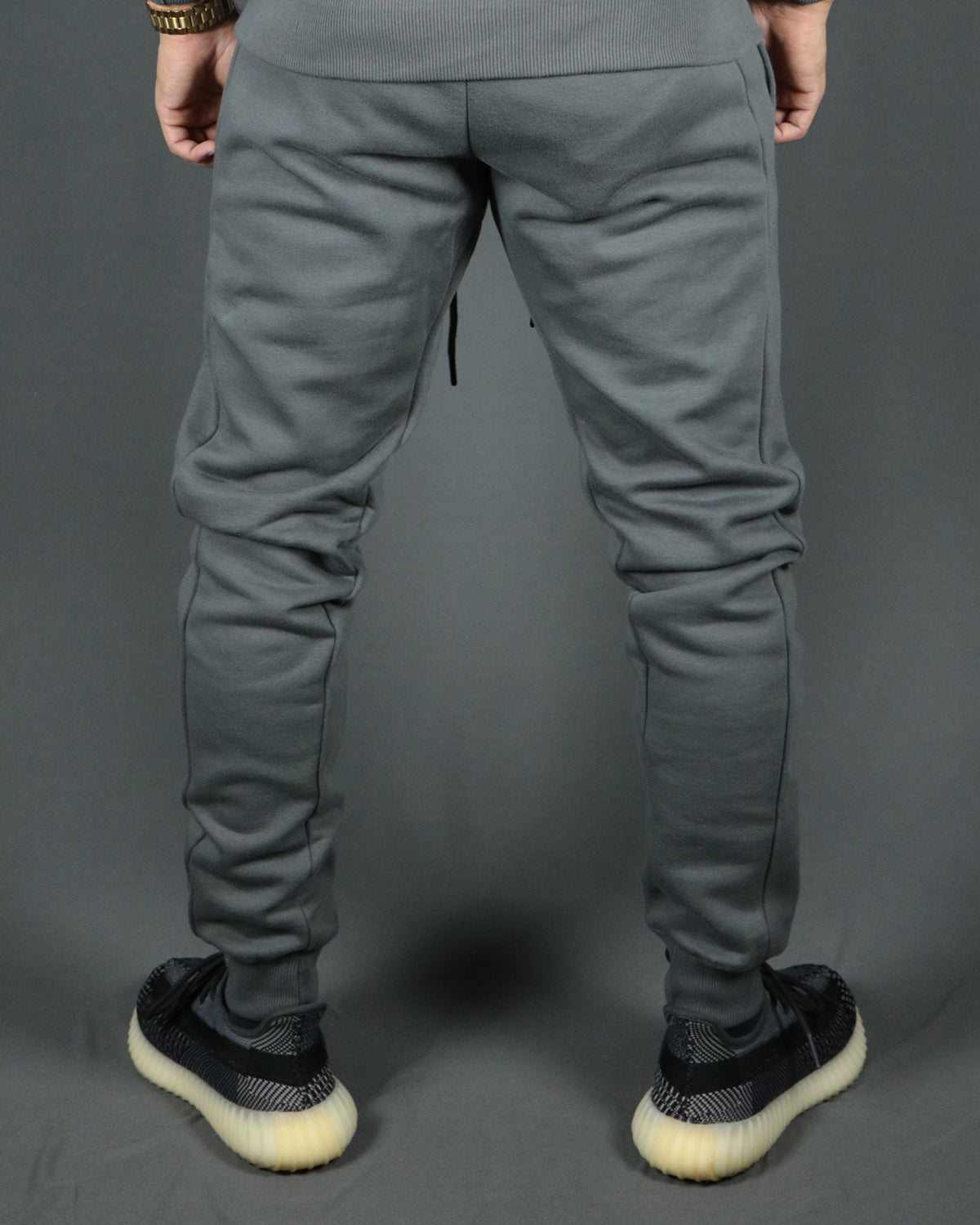 The back side of the Jordan Craig charcoal jogger pants with logo trim bottom.