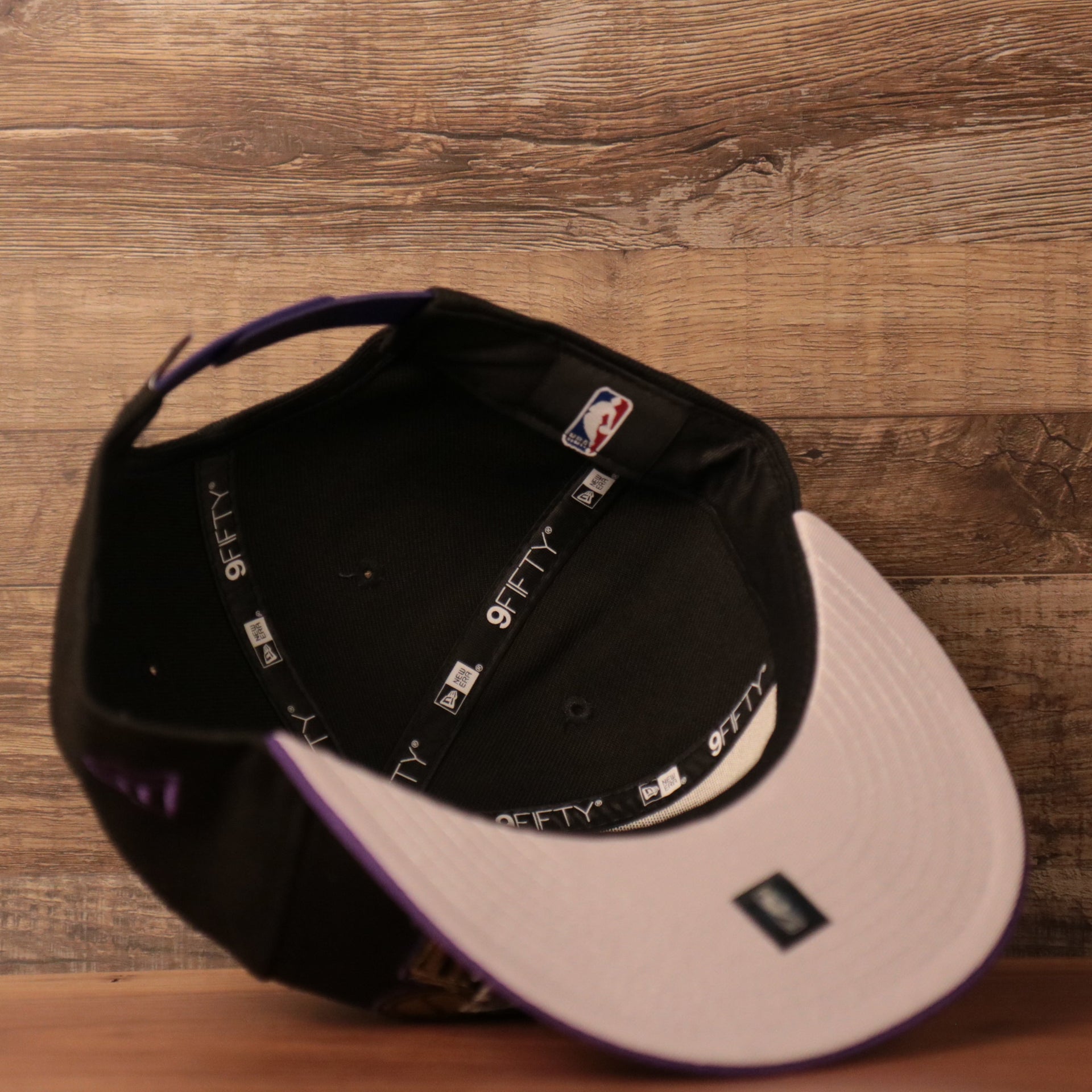 The Lakers NBA 2020 black/purple snapback hat with gray underbrim.