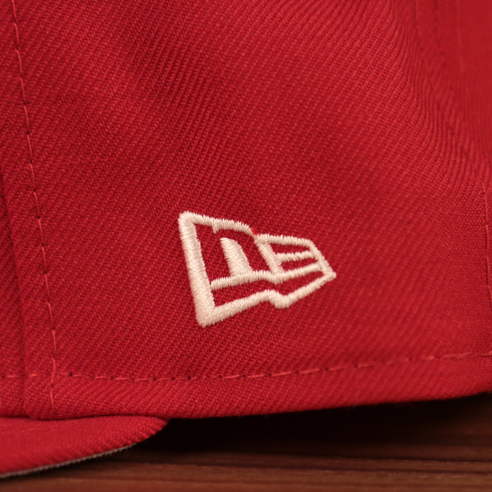 The wearer's left side of the red Philadelphia Phillies Philly Cheesesteka side patch fitted hat has the white New Era logo.