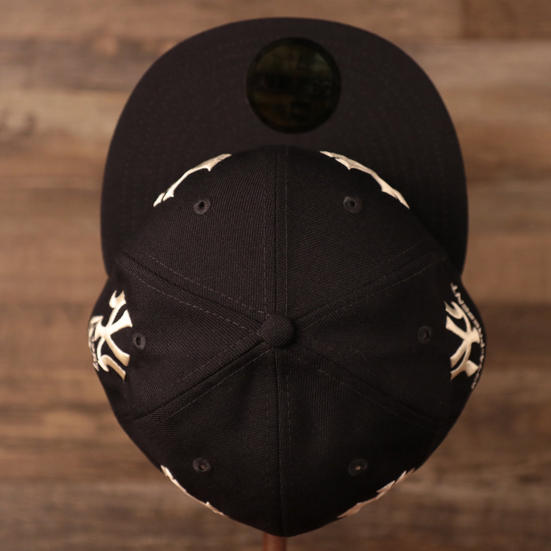 A navy 59fifty patch hat by New Era in a vintage design with all-over logo history of the Yankees.