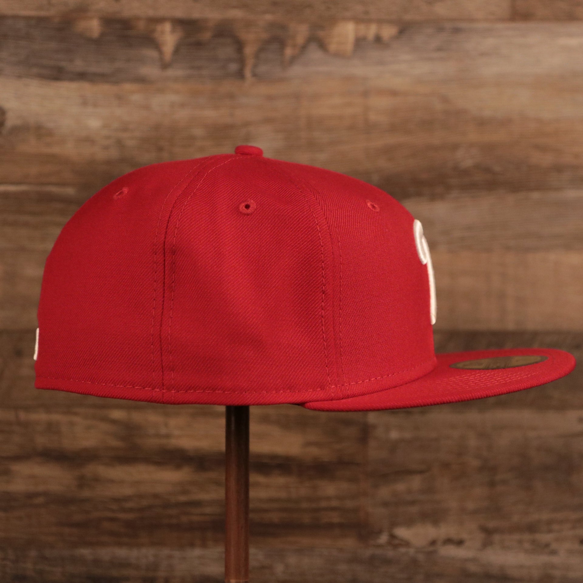 The wearer's right side of the red Philadelphia Phillies Philly Cheesesteak side patch fitted hat.