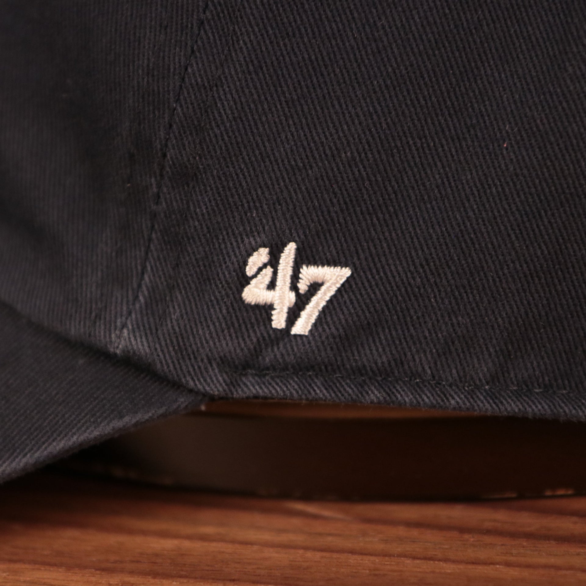 The wearer's left side of the dodgers pink bottom dad hat has the logo of 47 Brand.