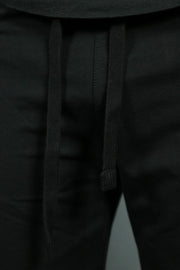 The black drawstrings of the black mens terry shorts by Jordan Craig.