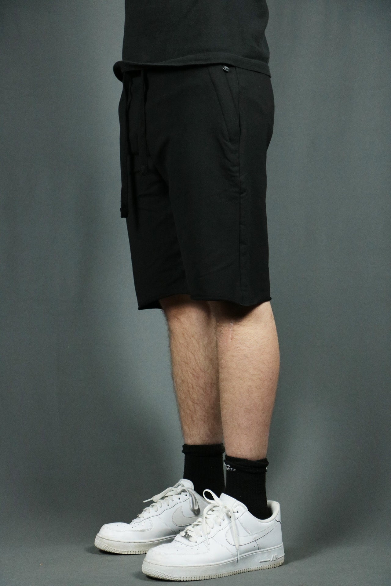 Model wearing the black men's french terry shorts by Jordan Craig.
