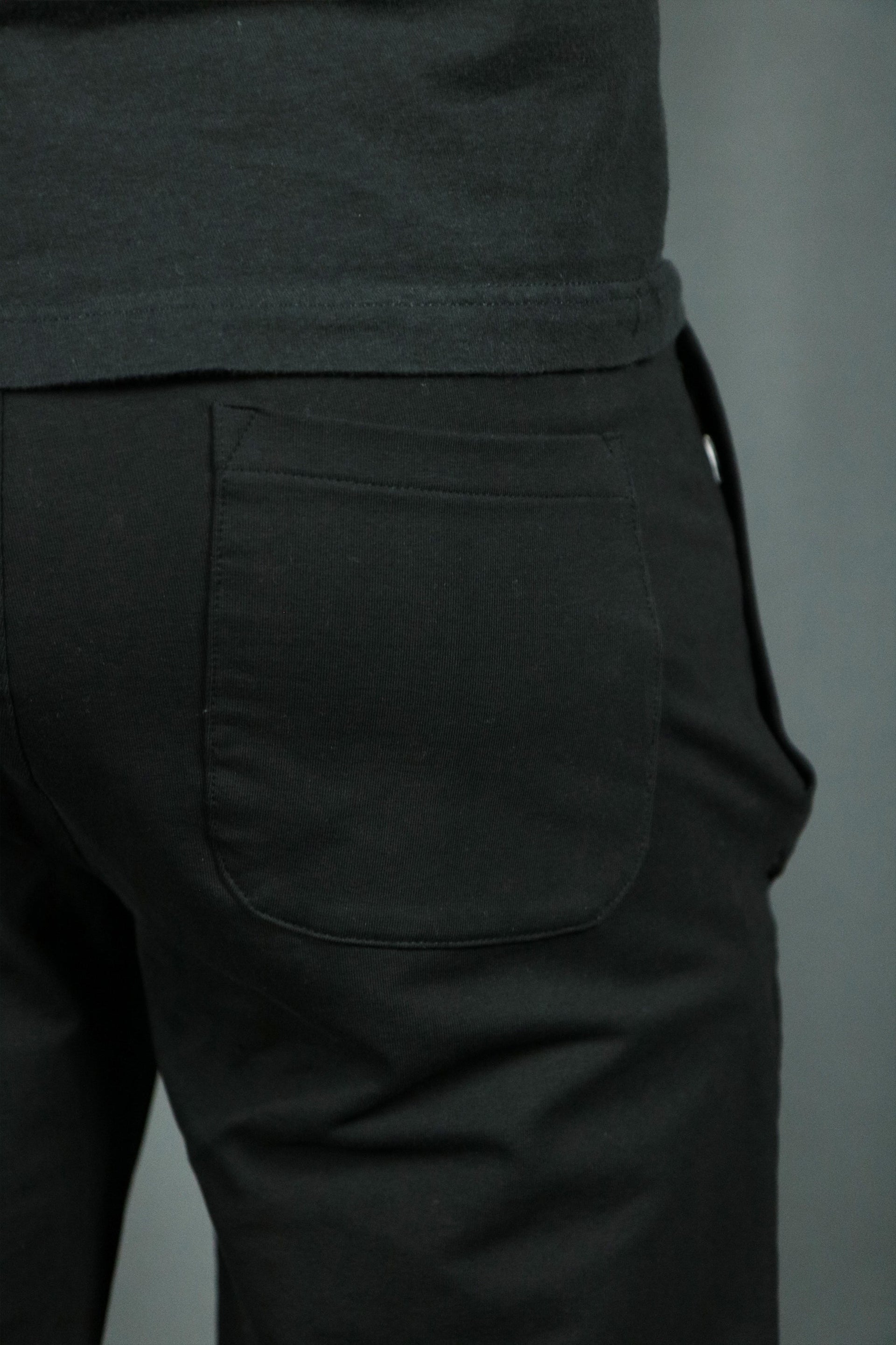The back pocket of the black mens terry cloth shorts.