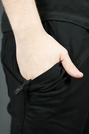 The zipped pocket of the black men's french terry shorts.