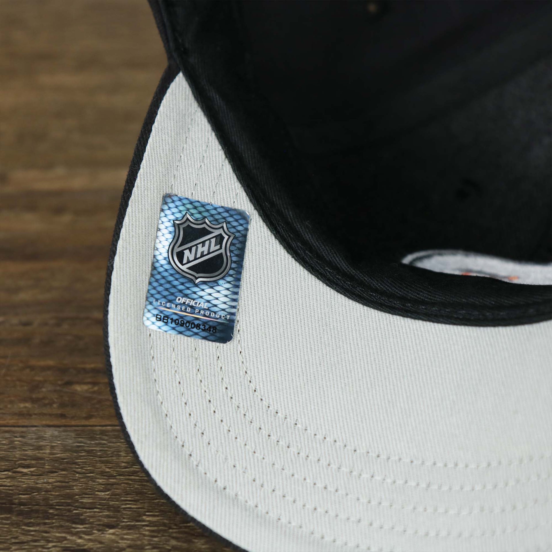 The NHL Official Product Sticker on the Infant Philadelphia Flyers Black Dad Hat | 47 Brand OSFM
