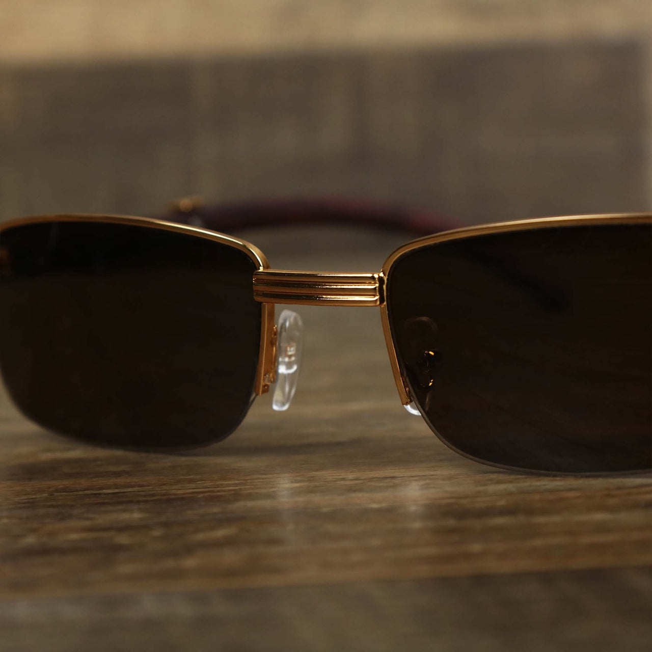 The hinge on the Rectangle 3 Row Frame Dark Brown Lens Sunglasses with Gold Frame