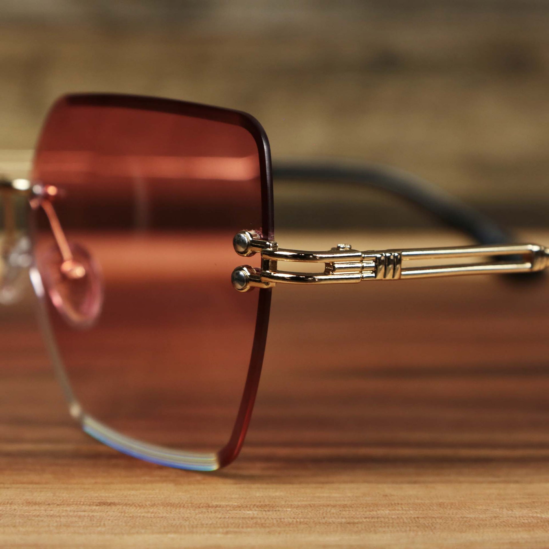 A close up of the hinge on the Large Lightweight Frame Pink Lens Sunglasses with Rose Gold Frame