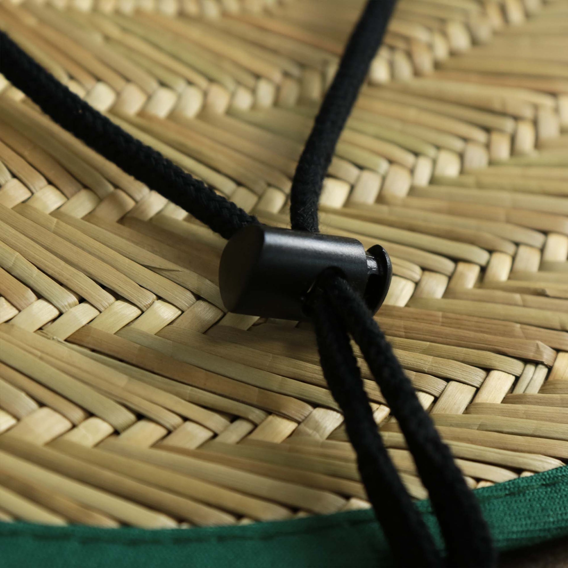 The adjustable chin strap on the New York Jets On Field 2022 Summer Training Straw Hat | New Era OSFM