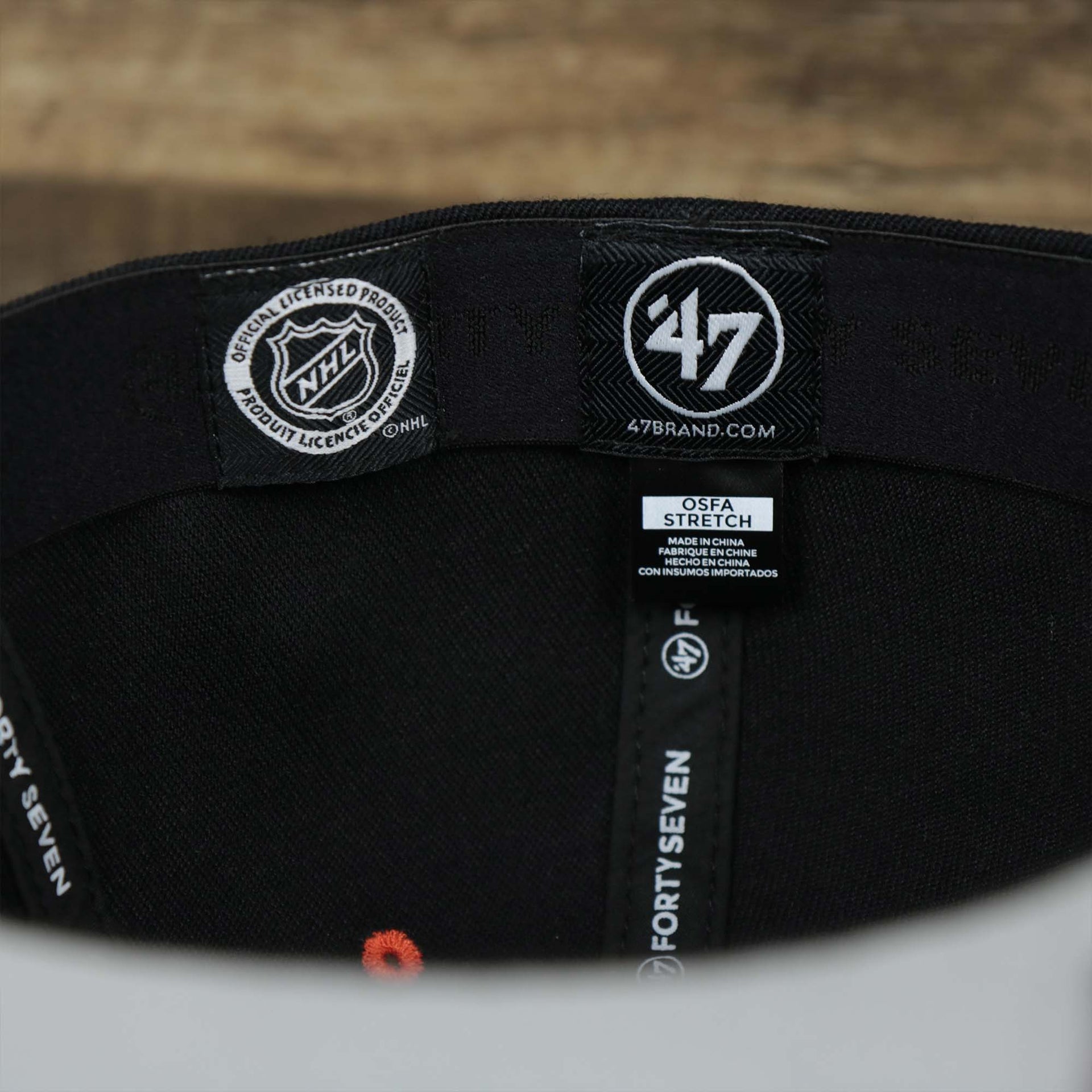 The Tags on the Philadelphia Flyers Side Patch Dugout Side Defender Fitted Cap | Black Stretch Fitted Cap