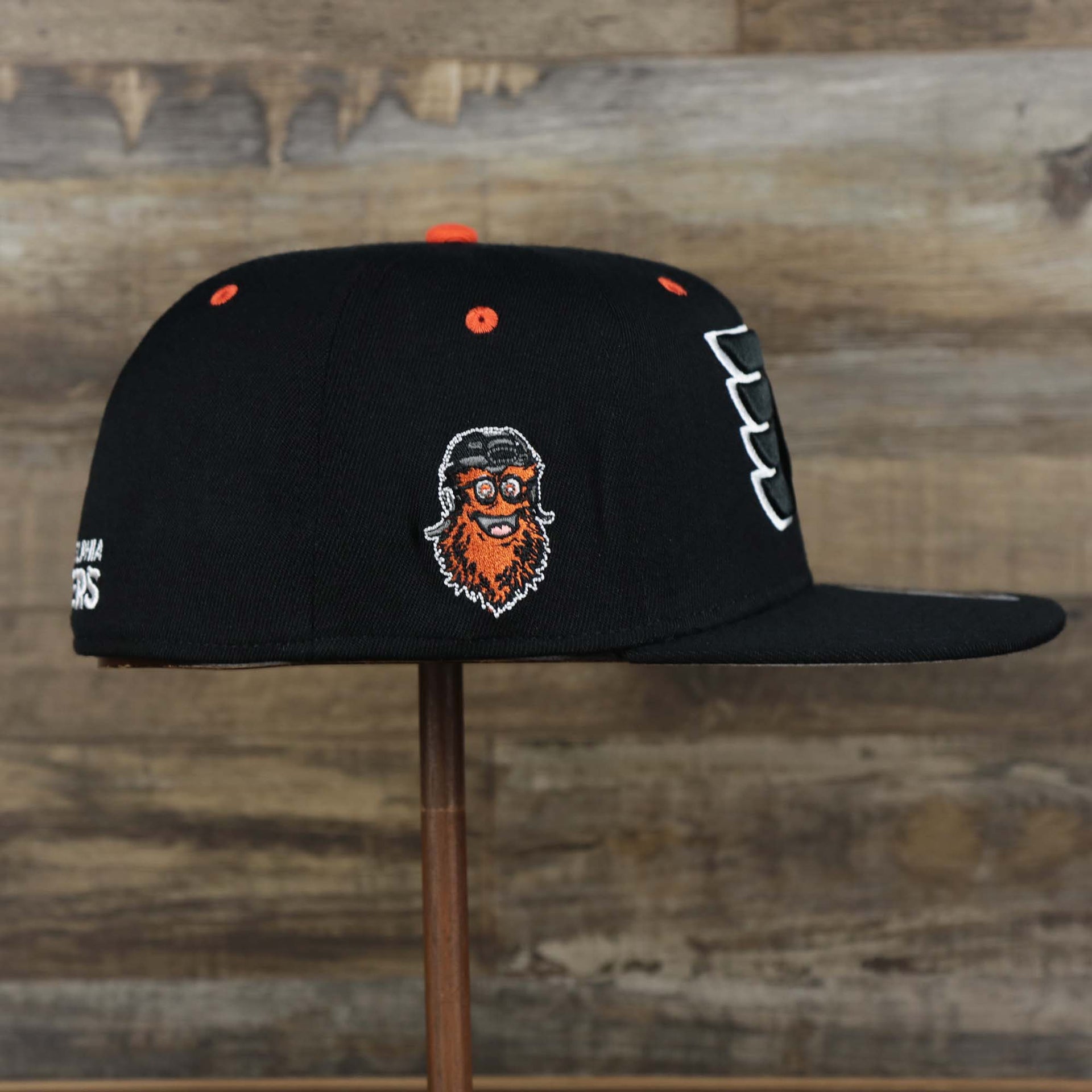 The wearer's right on the Philadelphia Flyers Side Patch Dugout Side Defender Fitted Cap | Black Stretch Fitted Cap