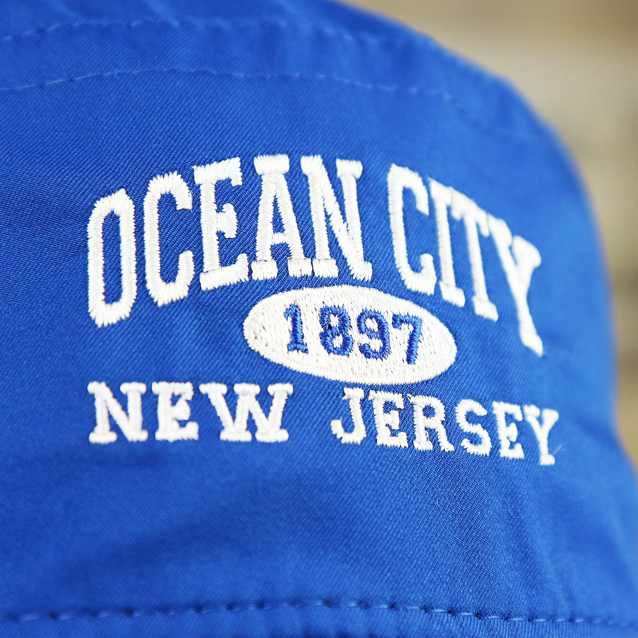 The Ocean City Wordmark on the Ocean City New Jersey Wordmark Since 1897 Bucket Hat | Royal Blue Bucket Hat