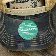 The Legacy Sticker on the Ocean City New Jersey Since 1897 Helm Patch Camo Print Mesh Back Trucker Hat | Camo Navy Blue Trucker Hat