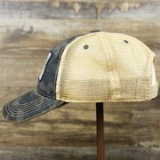 The wearer's left on the Ocean City New Jersey Since 1897 Helm Patch Camo Print Mesh Back Trucker Hat | Camo Navy Blue Trucker Hat