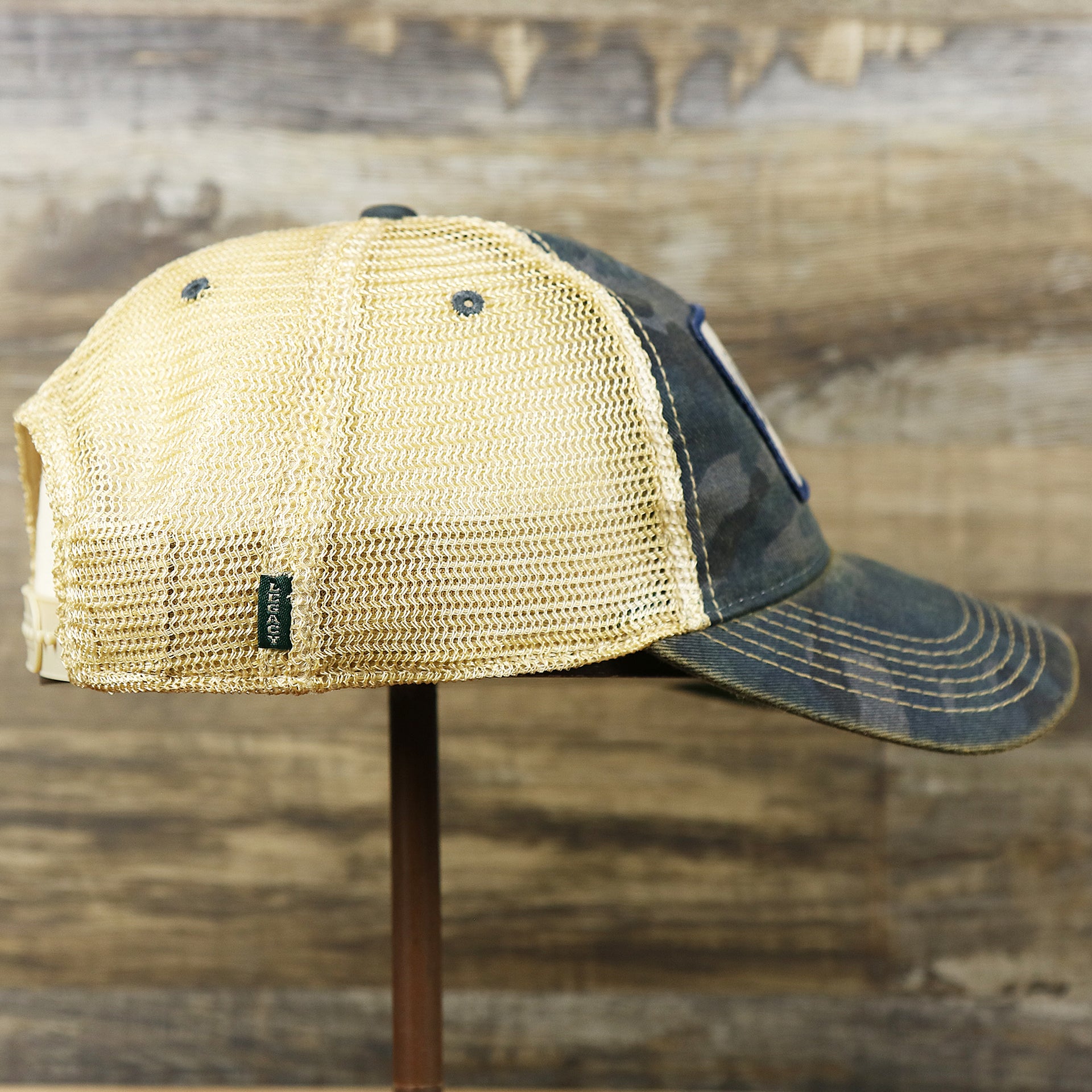 The wearer's right on the Ocean City New Jersey Since 1897 Helm Patch Camo Print Mesh Back Trucker Hat | Camo Navy Blue Trucker Hat