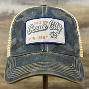 The front of the Ocean City New Jersey Since 1897 Helm Patch Camo Print Mesh Back Trucker Hat | Camo Navy Blue Trucker Hat