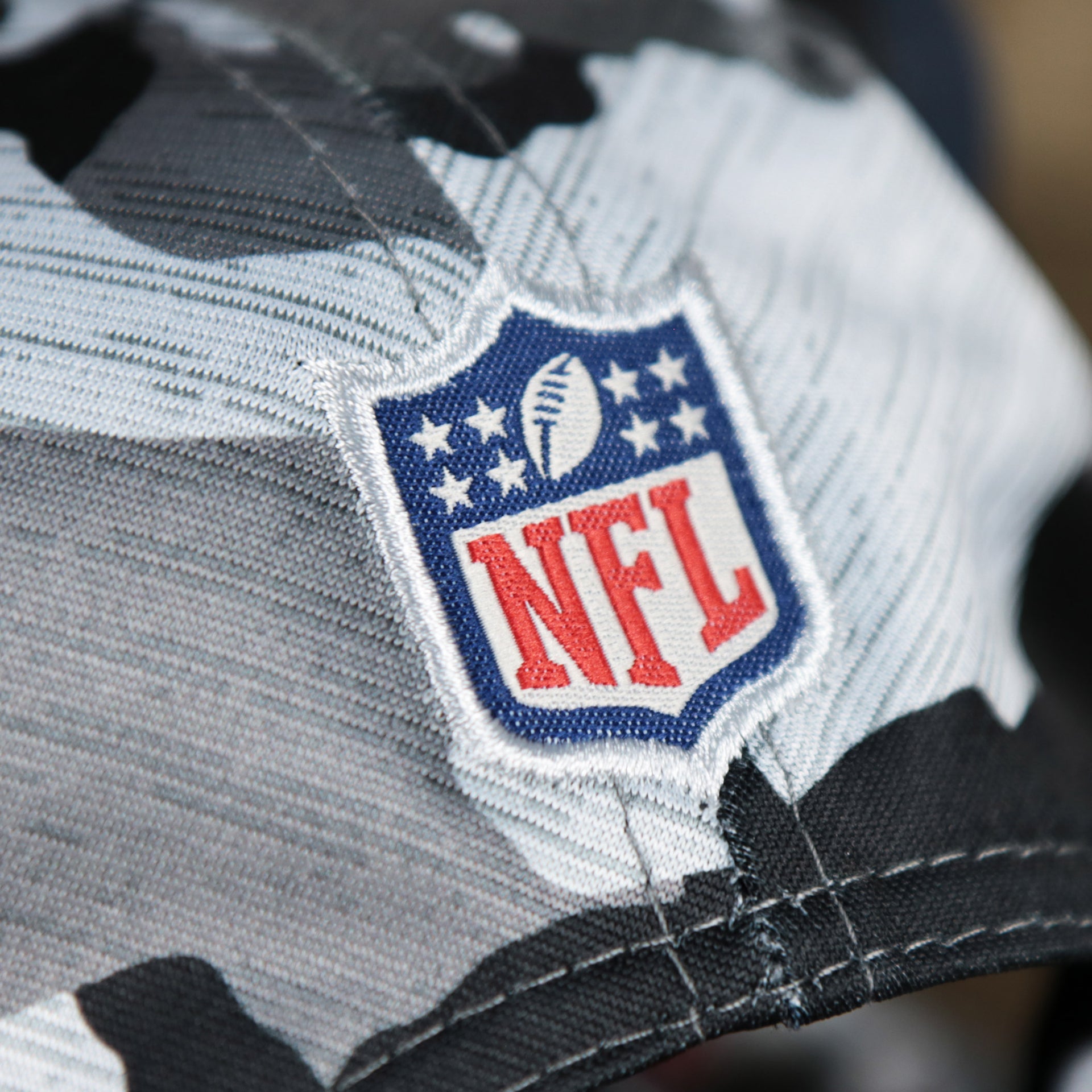 The NFL Logo on the back of the New England Patriots NFL OnField Summer Training 2022 Camo 9Fifty Snapback | Navy Blue Camo 9Fifty