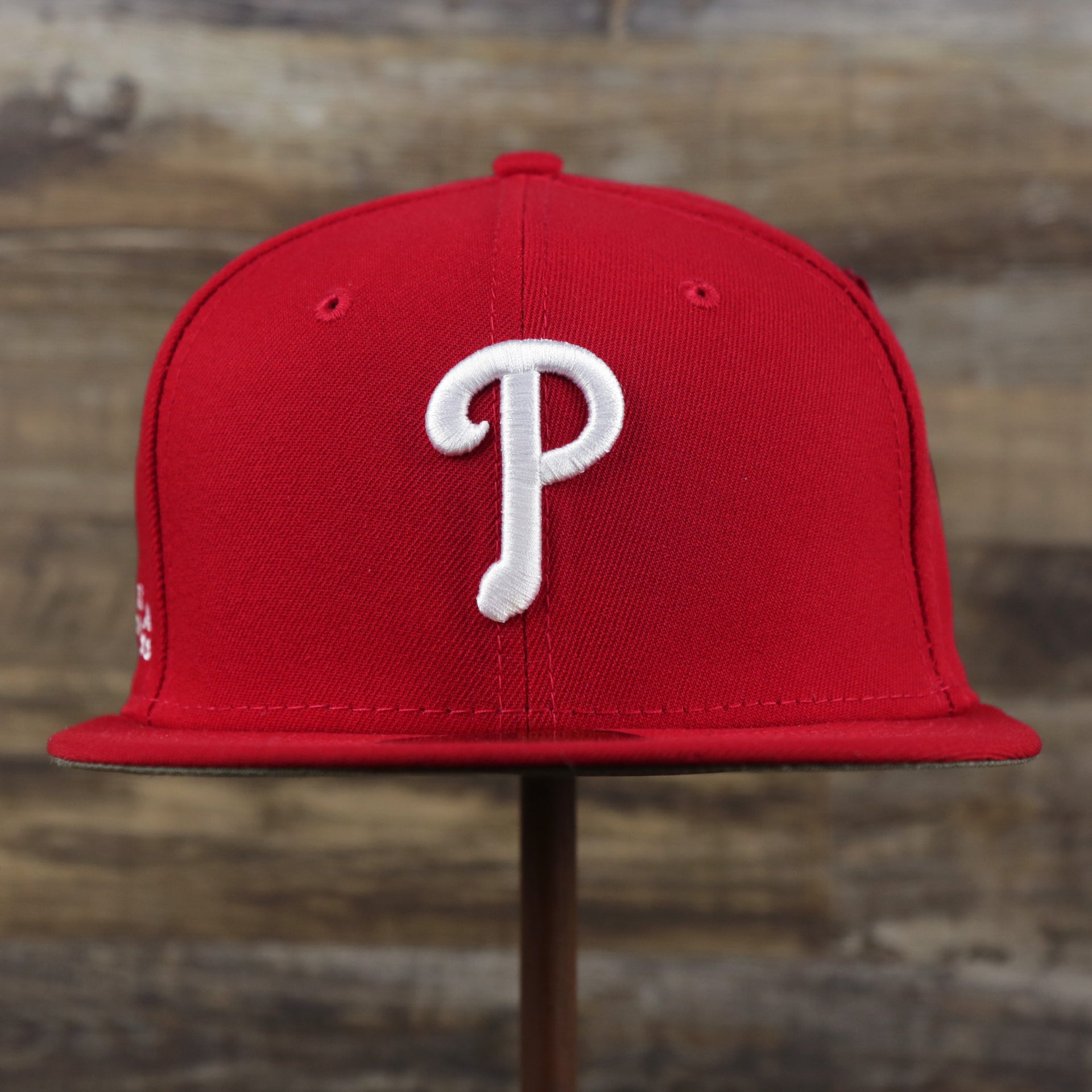 The front of the Philadelphia Phillies Alpha Industries Side Patch Army Green Undervisor 59FIfty Fitted Cap With Hangtag | Red 59FIfty Cap