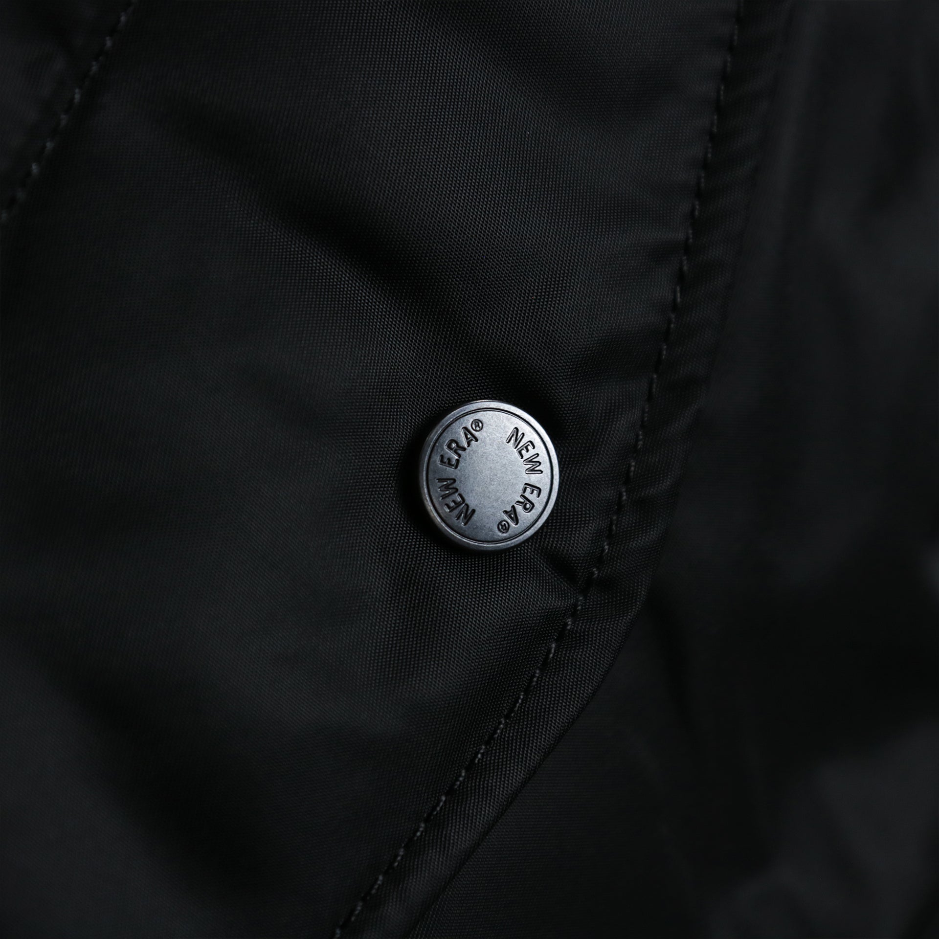 A custom metal button with the New Era Wordmark on the Cooperstown Philadelphia Phillies MLB Patch Alpha Industries Reversible Bomber Jacket With Camo Liner | Black Bomber Jacket