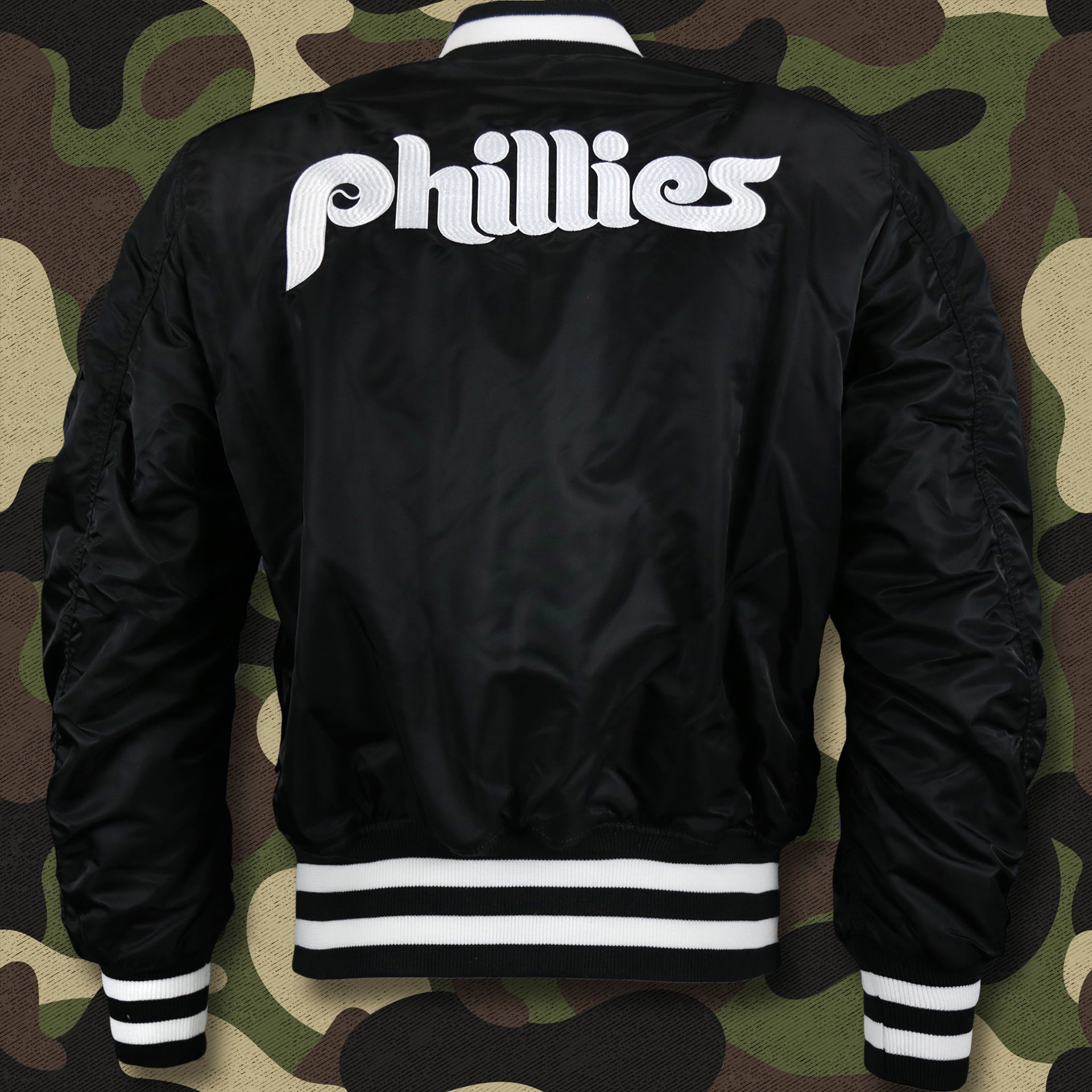 The backside of the Cooperstown Philadelphia Phillies MLB Patch Alpha Industries Reversible Bomber Jacket With Camo Liner | Black Bomber Jacket