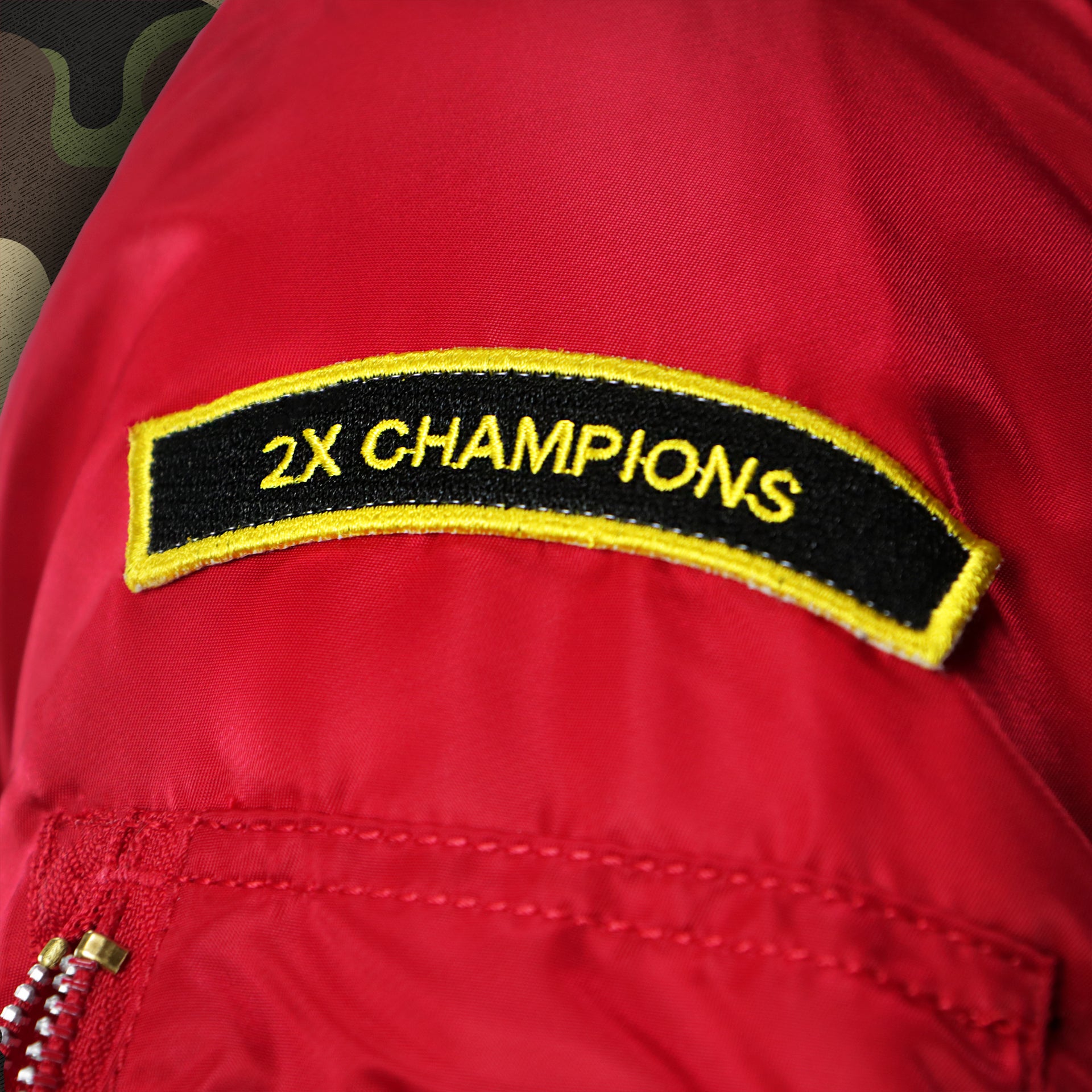 The 2X Champions Side Patch on the Philadelphia Phillies MLB Patch Alpha Industries Reversible Bomber Jacket With Camo Liner | Red Bomber Jacket