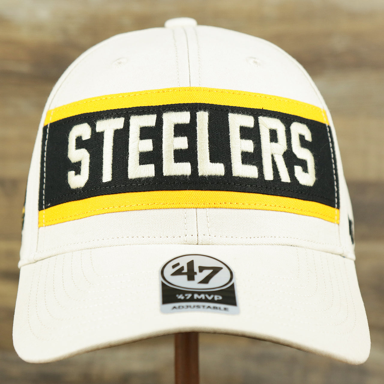 The front of the Throwback Pittsburgh Steelers Striped Wordmark Legacy Steelers Side Patch Crossroad Dad Hat | Bone Dad Hat