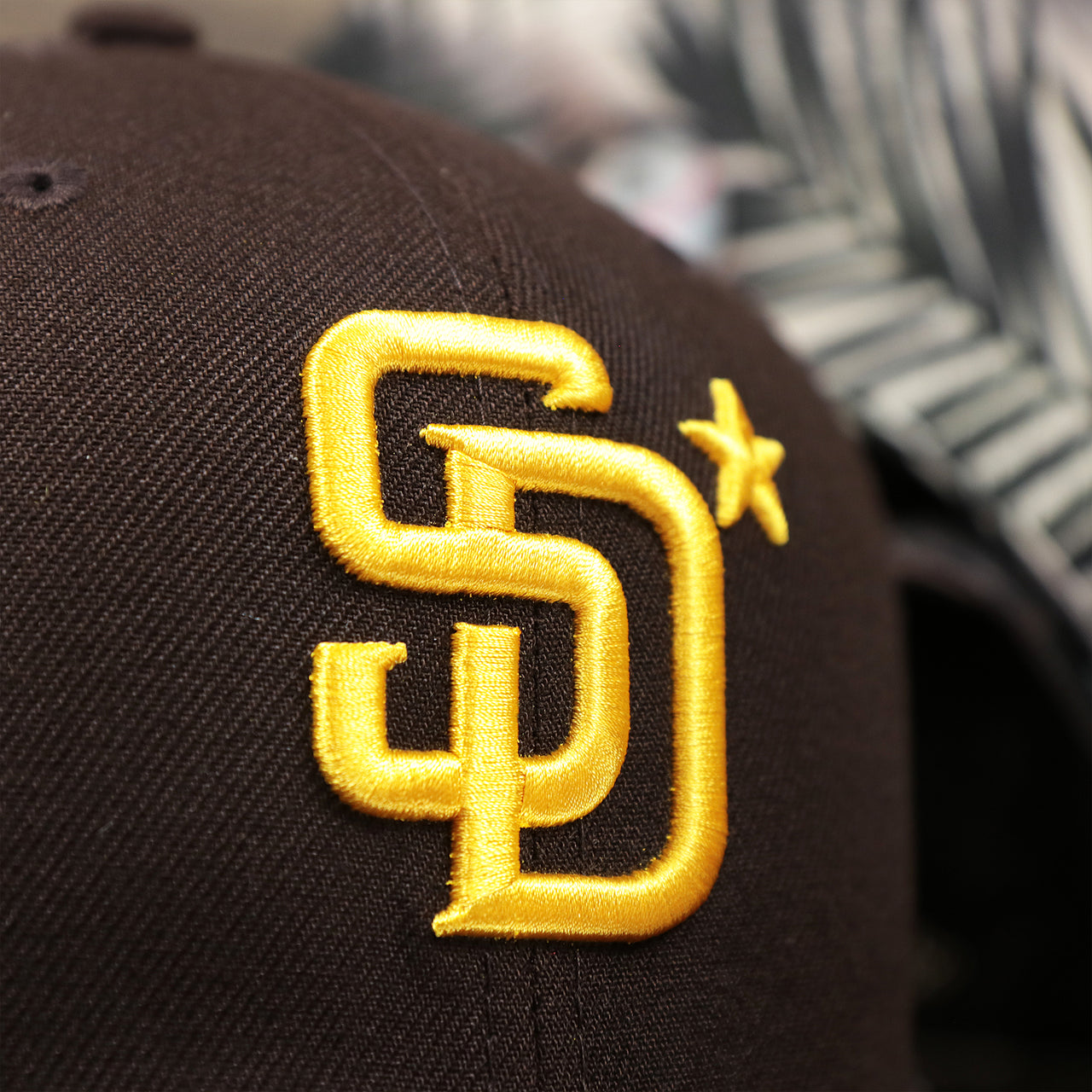 The Padres Logo on the San Diego Padres Metallic All Star Game MLB 2022 Side Patch 9Fifty Mesh Snapback | ASG 2022 Brown Trucker Hat