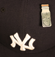 The New York Nut Cracker Drink Fitted Cap Pin | Enamel Pin For Hat on a fitted