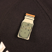 A close up of the New York Nut Cracker Drink Fitted Cap Pin | Enamel Pin For Hat
