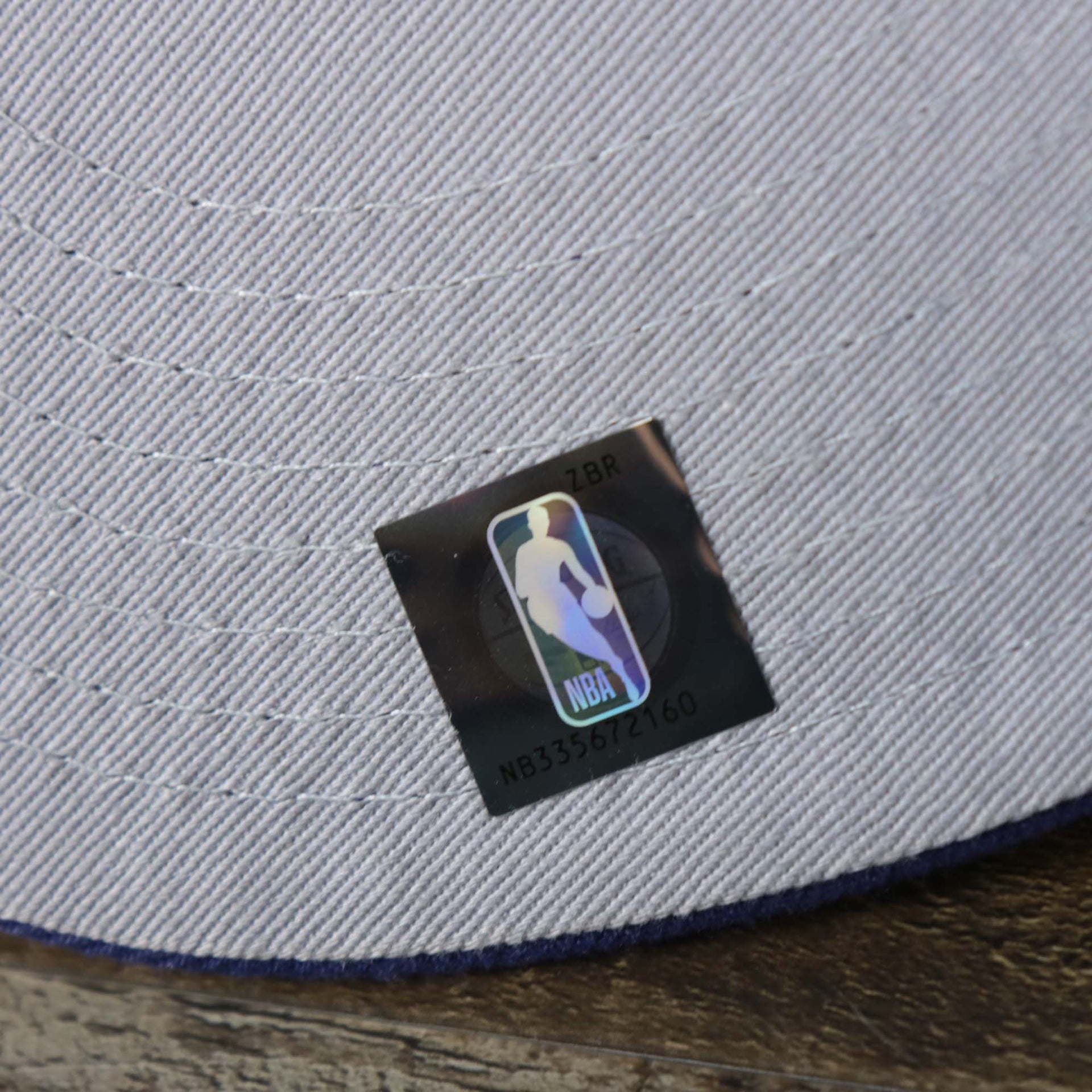 The NBA Jerry West Sticker on the Phoenix Suns NBA 2022 Draft Gray Bottom 9Fifty Snapback | New Era Cream/Purple